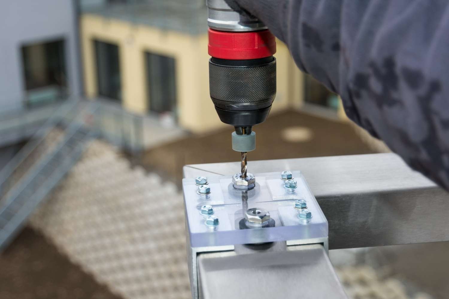 Closeup of drilling holes using a jig bushing for precise guide of twist drill bit